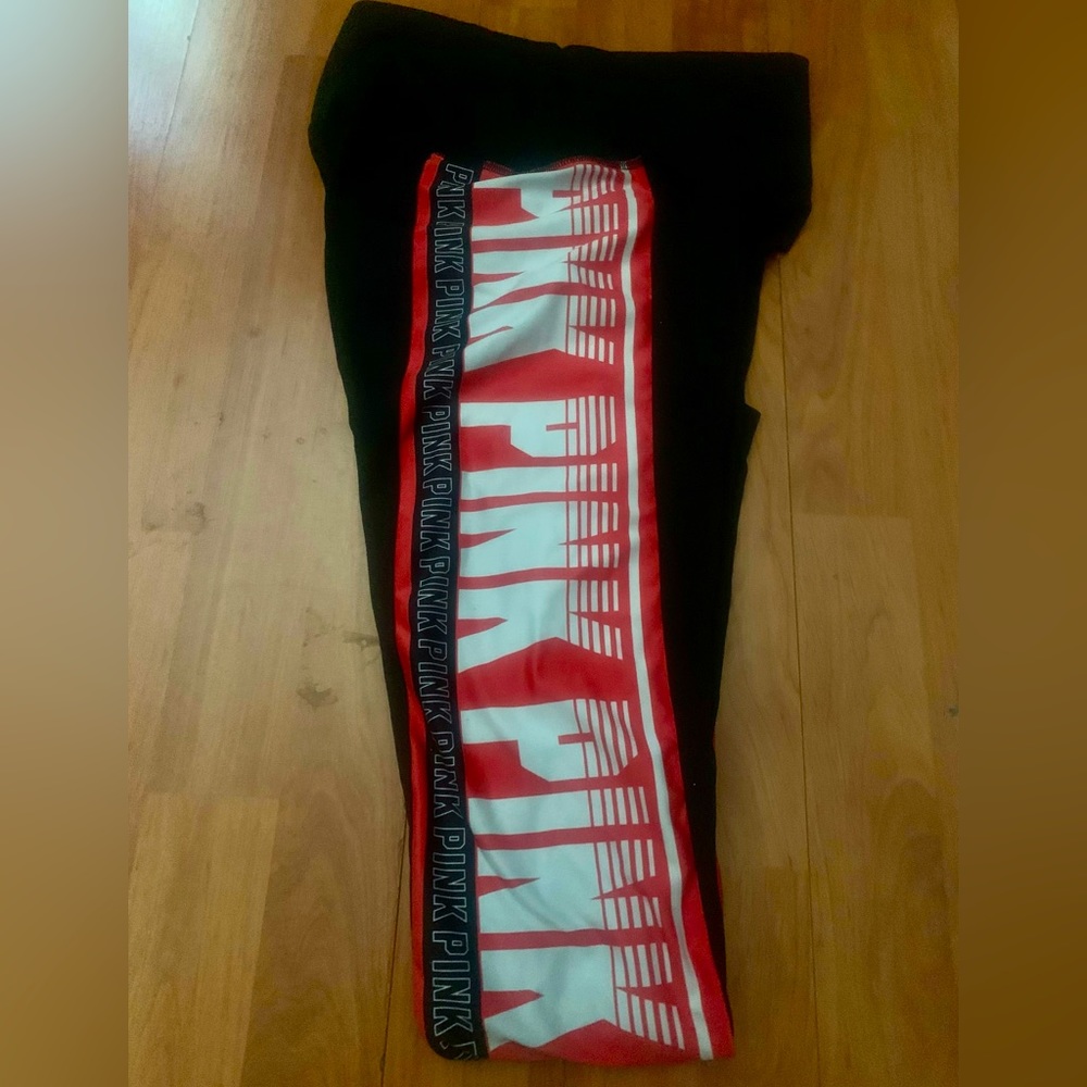 PINK victoria secret black leggings with orange logo stripe on left side